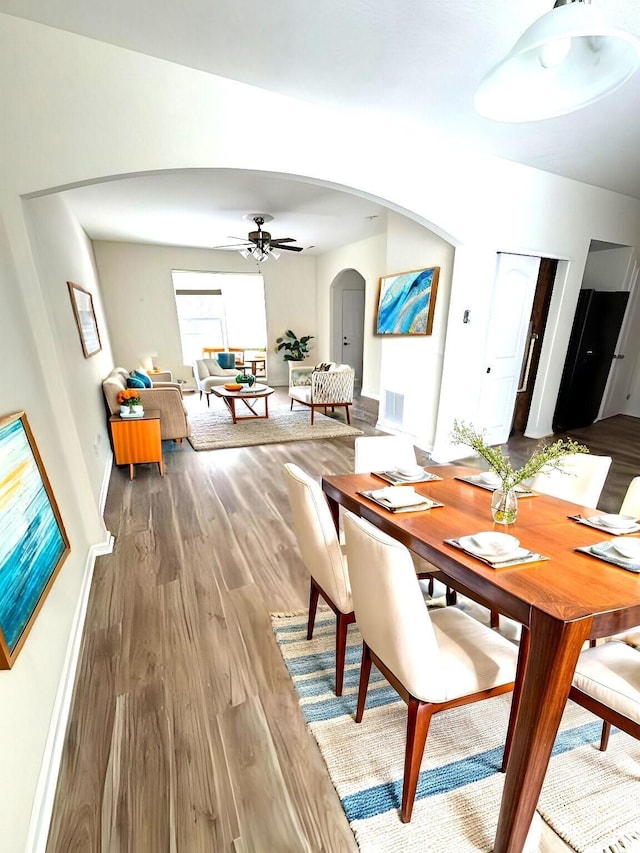 dining area featuring ceiling fan and wood-type flooring