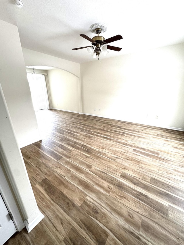 unfurnished room featuring ceiling fan and hardwood / wood-style floors