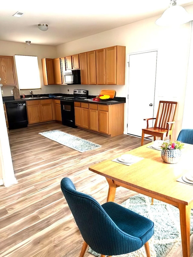 kitchen featuring black appliances and light wood-type flooring