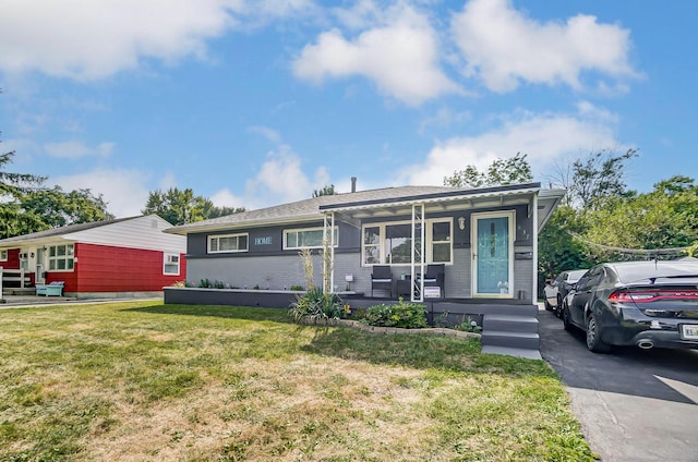 view of front of property featuring covered porch and a front yard