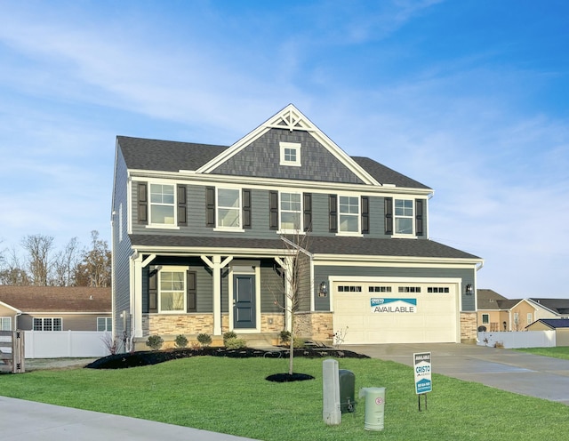 view of front of property with a porch, a garage, and a front yard