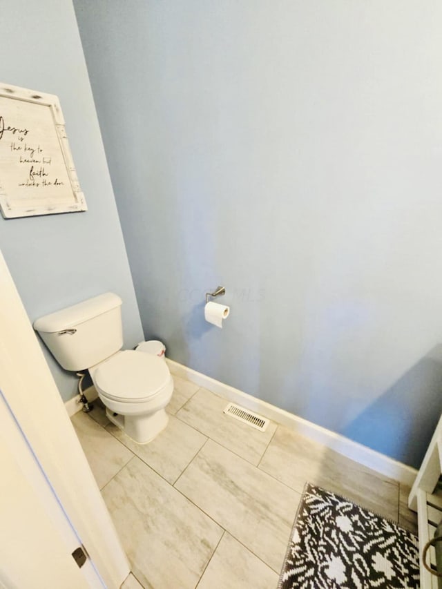 bathroom featuring tile patterned flooring and toilet