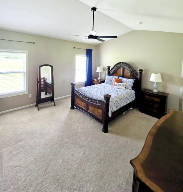 bedroom with ceiling fan, lofted ceiling, and light carpet