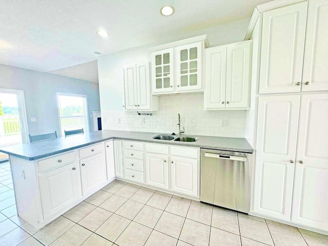 kitchen with white cabinetry, dishwasher, sink, kitchen peninsula, and light tile patterned floors