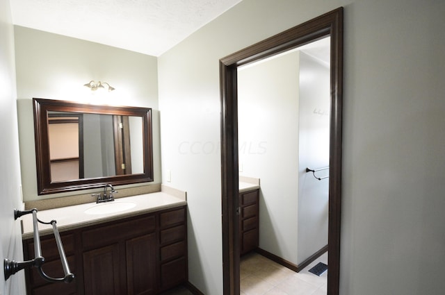 bathroom with a textured ceiling and vanity