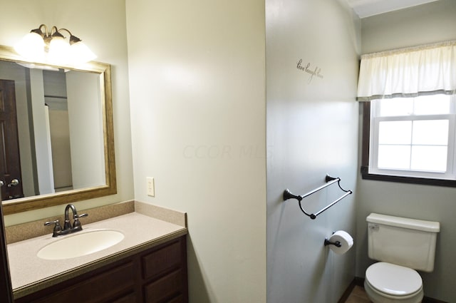 bathroom with toilet and vanity