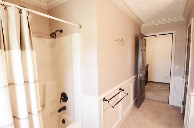 bathroom with ornamental molding and shower / tub combo