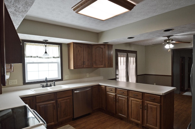 kitchen with sink, range with electric cooktop, a textured ceiling, kitchen peninsula, and stainless steel dishwasher