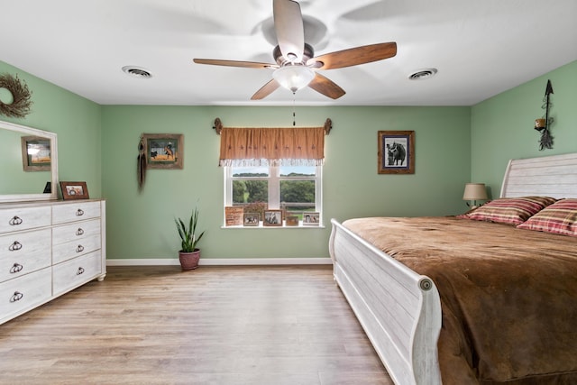 bedroom featuring baseboards, visible vents, and light wood-style floors