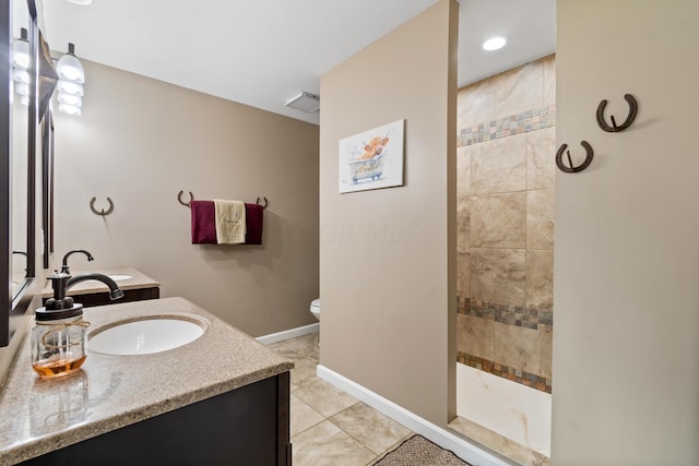 full bath with baseboards, toilet, tile patterned floors, vanity, and a walk in shower