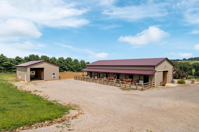 exterior space featuring driveway, an exterior structure, and an outbuilding