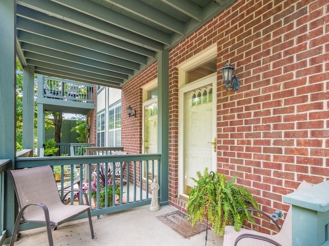 exterior space featuring a balcony and covered porch