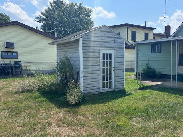 view of outbuilding with a lawn