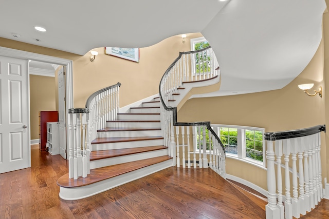 staircase featuring a wealth of natural light and hardwood / wood-style floors