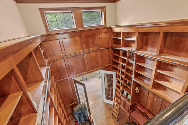 wine area with wood-type flooring and crown molding