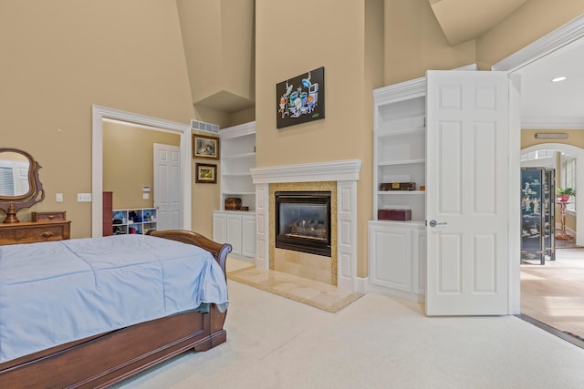 bedroom featuring a fireplace, carpet, and high vaulted ceiling