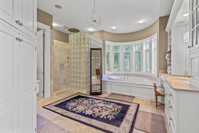 bathroom featuring tile patterned flooring, vanity, a chandelier, and separate shower and tub