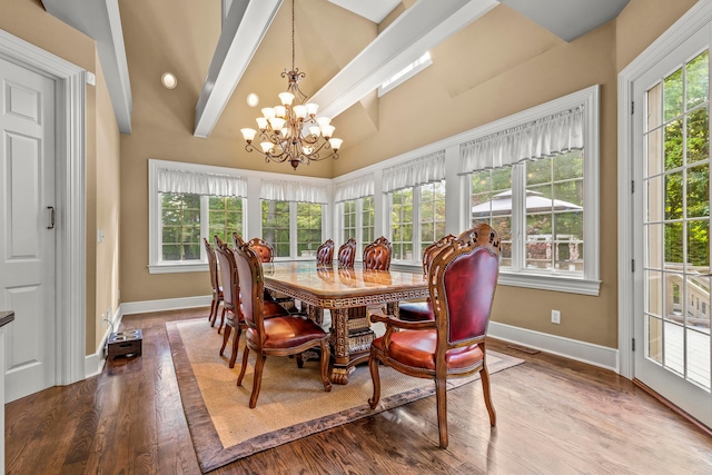 dining area with hardwood / wood-style floors, a notable chandelier, plenty of natural light, and beamed ceiling