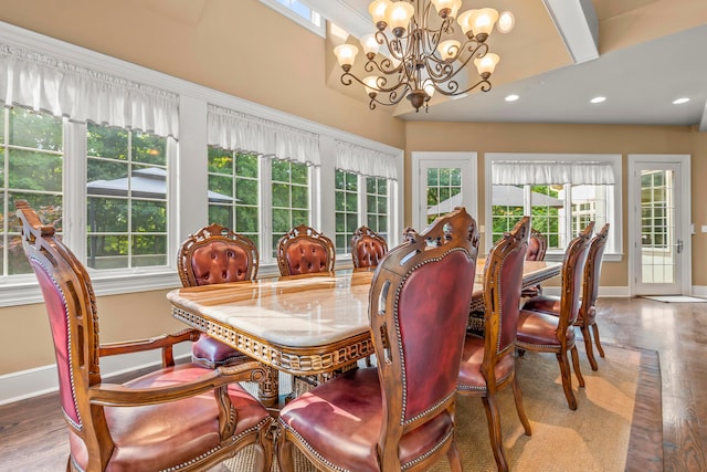 dining area featuring a chandelier, wood-type flooring, and beamed ceiling