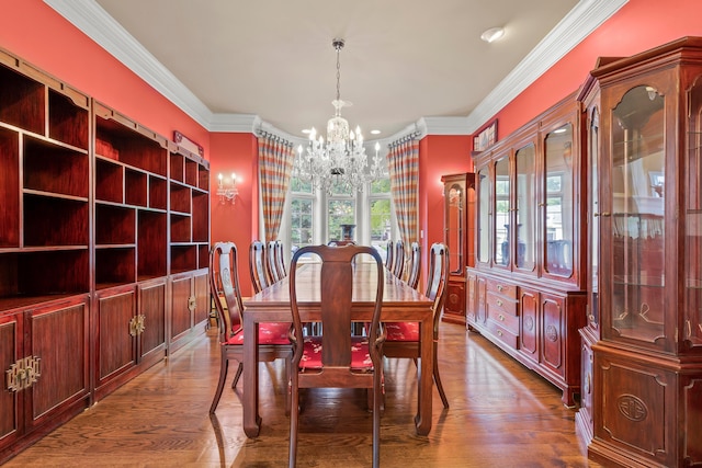 dining area with hardwood / wood-style flooring, a notable chandelier, and ornamental molding