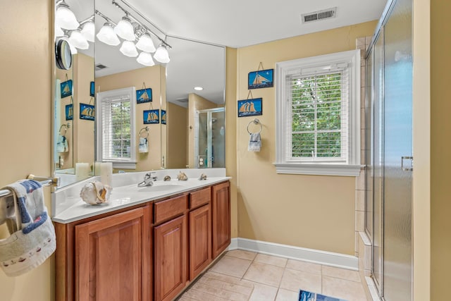 bathroom featuring tile patterned floors, vanity, and a shower with door