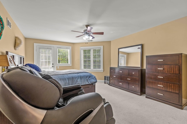 bedroom with ceiling fan and light colored carpet