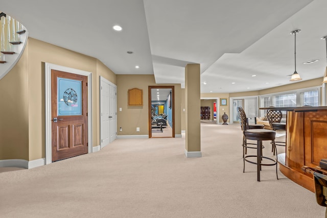 carpeted entrance foyer with bar area