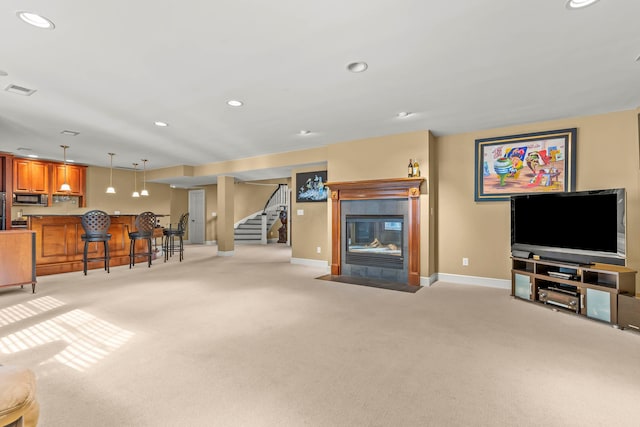 living room featuring light carpet and indoor bar