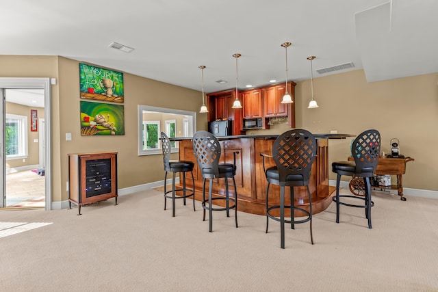 kitchen featuring a wealth of natural light, black appliances, and light carpet