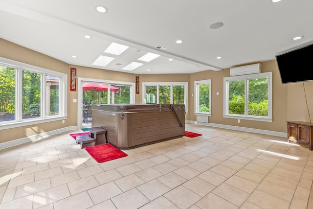 interior space with a jacuzzi and a skylight