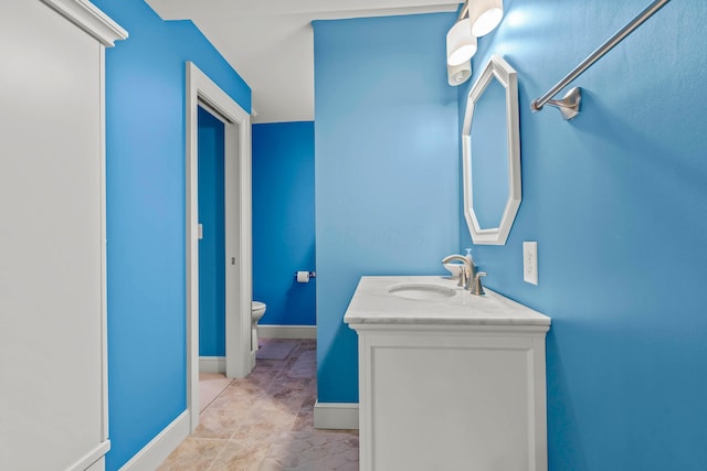 bathroom featuring tile patterned floors, vanity, and toilet