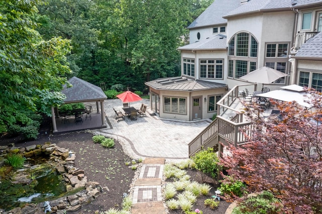 rear view of house featuring a gazebo