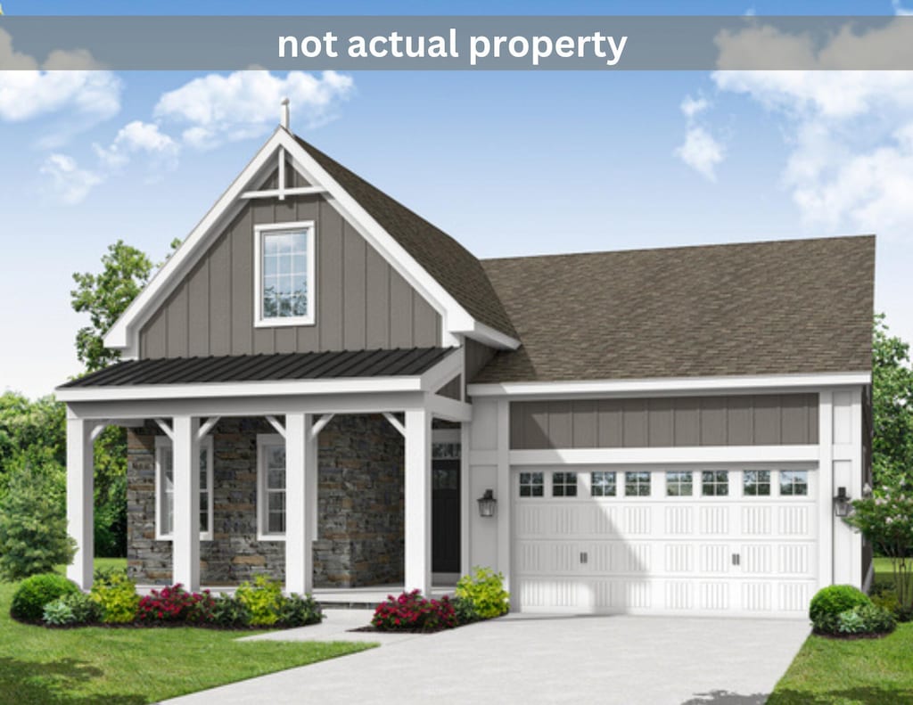 view of front facade with a porch, a garage, and a front lawn