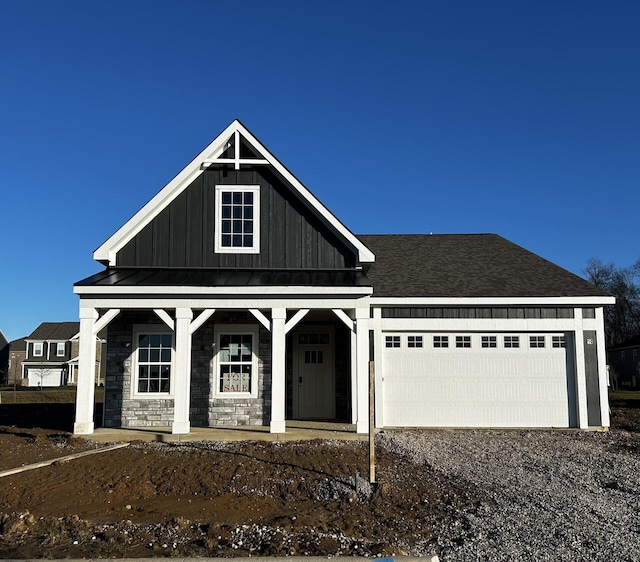 view of front of house with covered porch and a garage