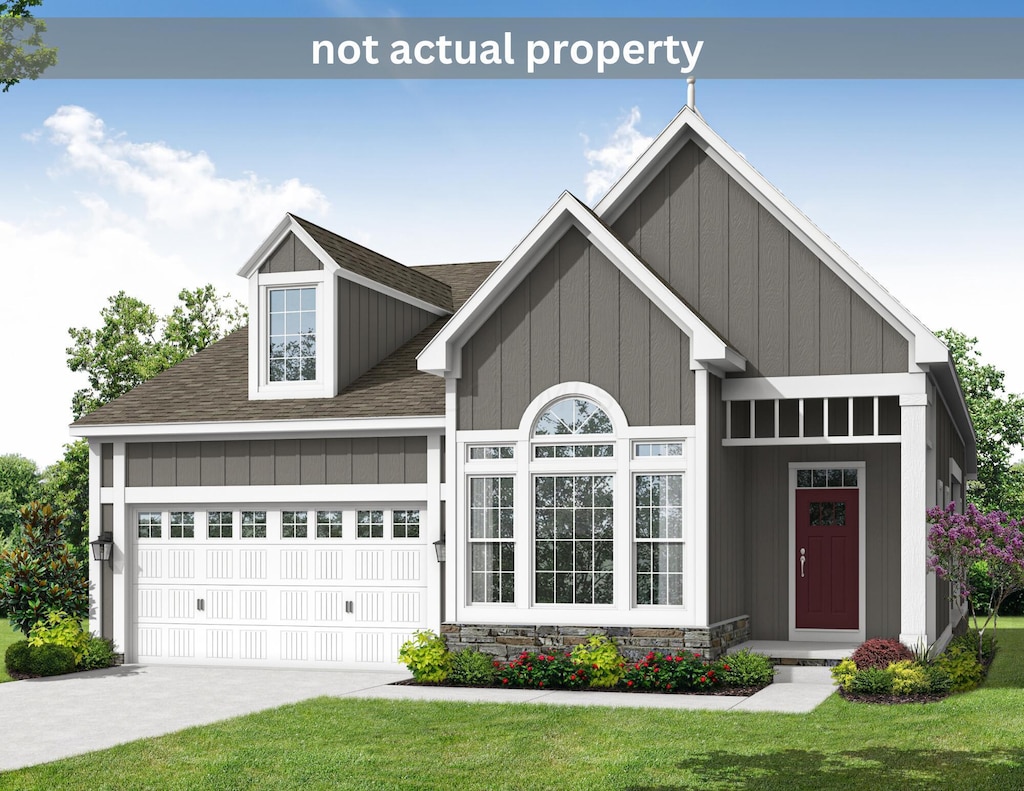 view of front of house featuring a garage and a front lawn