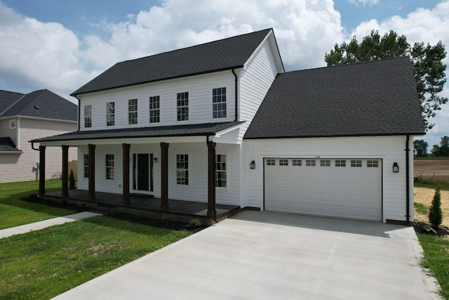 view of front of house with covered porch, a front yard, and a garage