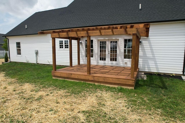 rear view of house featuring a pergola, a deck, a yard, and french doors