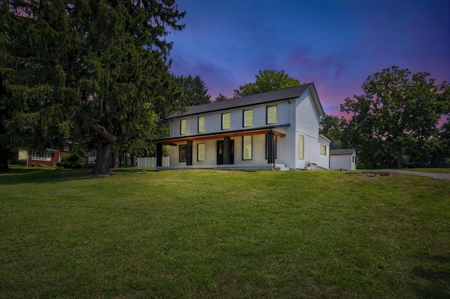 view of front facade with a porch and a yard