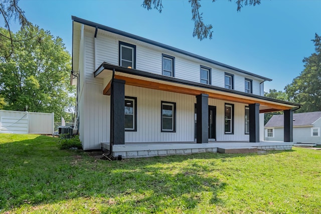 view of front of house featuring covered porch, cooling unit, and a front yard