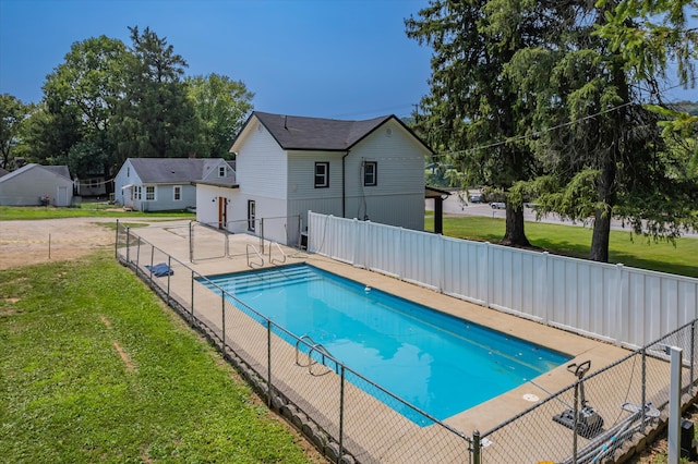 view of pool with a yard