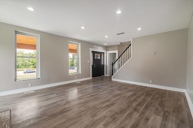 unfurnished living room with dark wood-type flooring