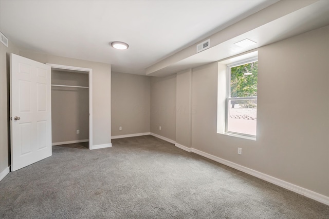 unfurnished bedroom with carpet and a closet