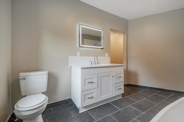 bathroom featuring tile patterned flooring, vanity, and toilet