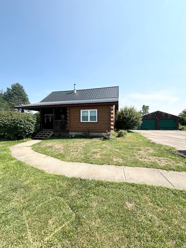 log cabin featuring an outbuilding, a front lawn, and a porch