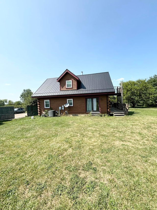 back of property featuring a lawn and central AC unit