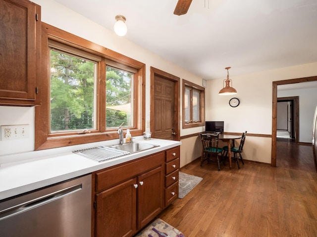 kitchen with ceiling fan, sink, hanging light fixtures, dark hardwood / wood-style flooring, and stainless steel dishwasher