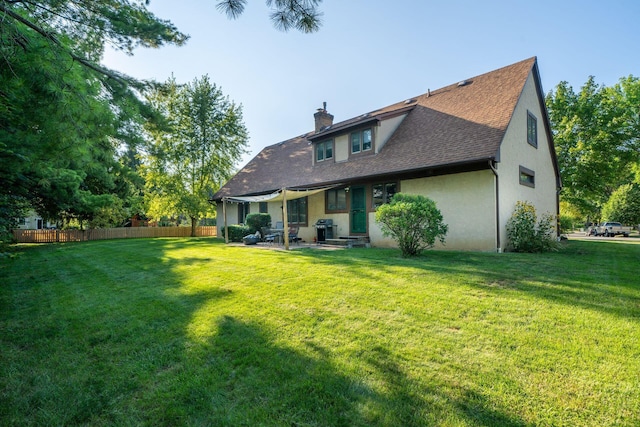 rear view of property with a patio area and a yard