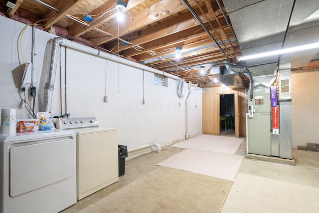 basement featuring heating unit and washer and dryer