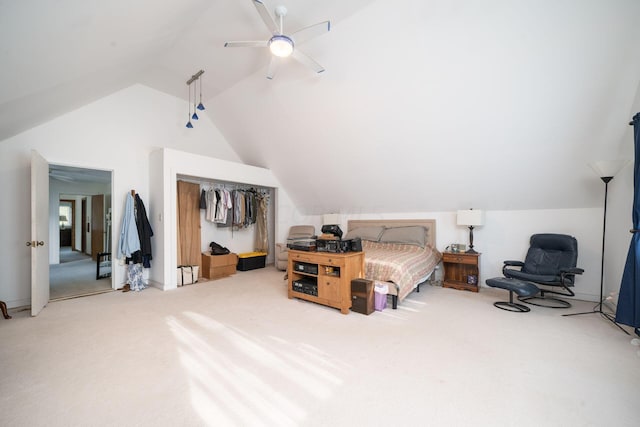 carpeted bedroom featuring a closet, lofted ceiling, and ceiling fan