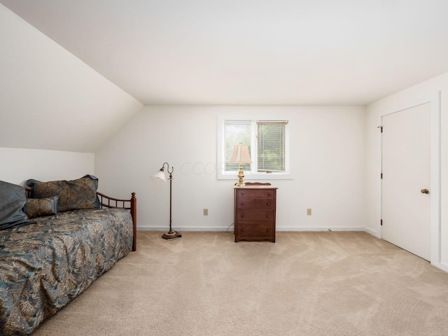 bedroom with light carpet and vaulted ceiling